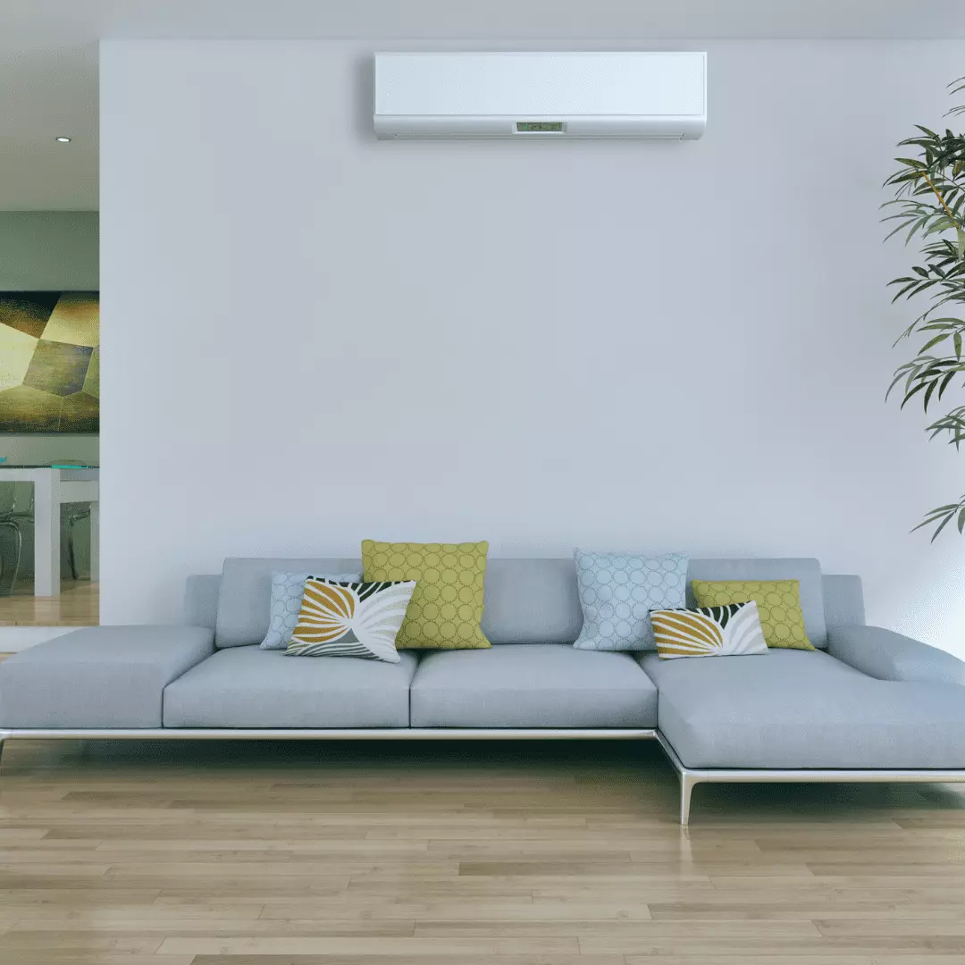 Foto de uma sala com um sofá em uma parede cinza e um ar condicionado em cima